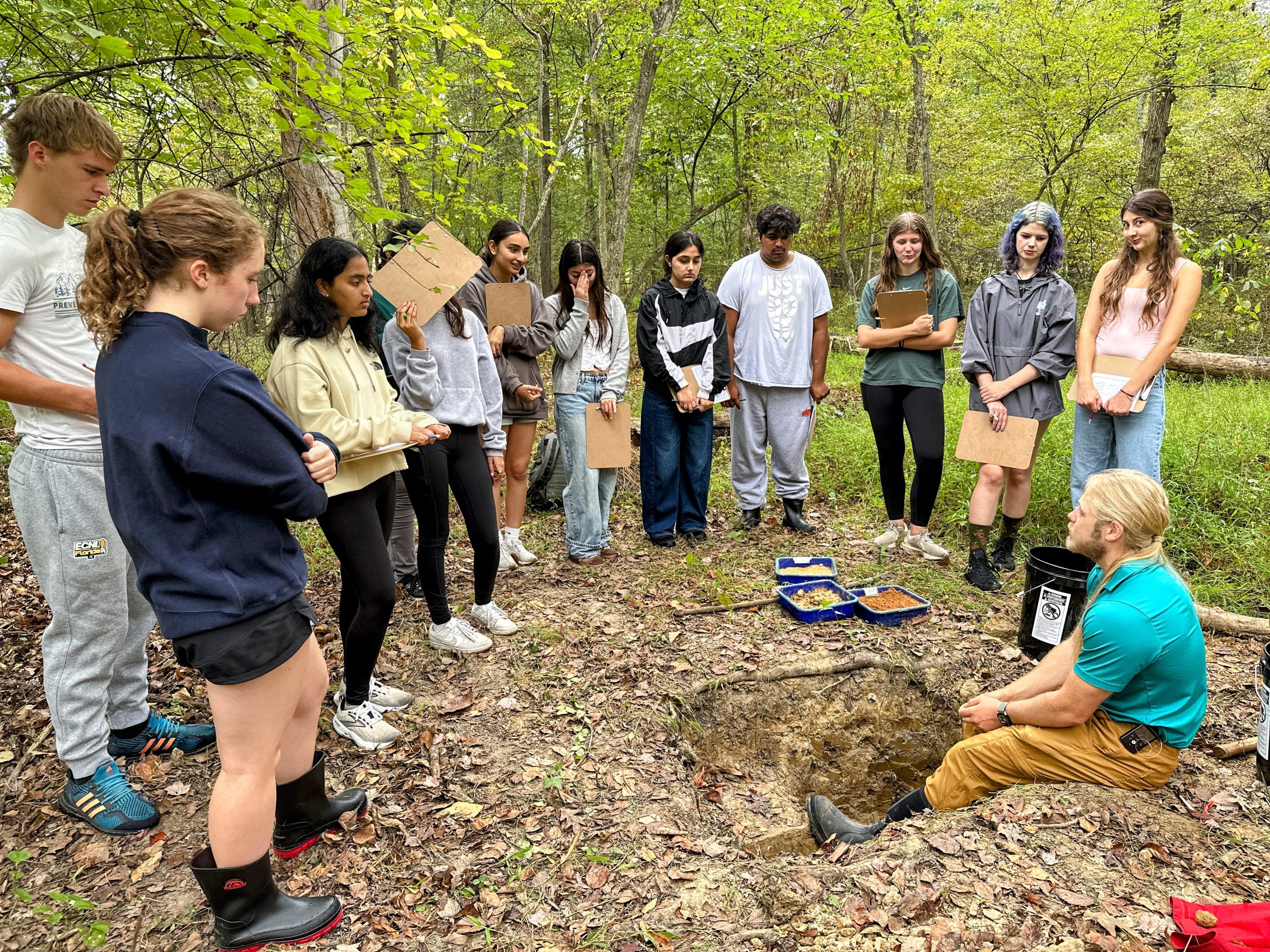 Students learning from a soil pit demonstration 