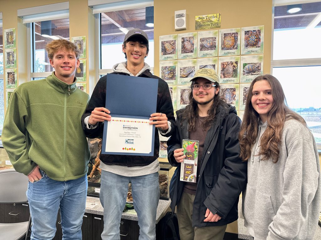 Four students accepting their local Envirothon award and prize.